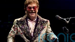 Elton John pauses farewell tour after testing positive for Covid-19