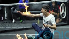 Protester sets his arm on fire during Laver Cup match in London