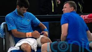 Novak Djokovic plays through the pain to beat Grigor Dimitrov at Australian Open