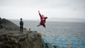 Crowds &ndash; including the &lsquo;Forty Foot Santa&rsquo; &ndash; take part in Christmas Day swim