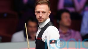 Judd Trump brushes off cue confusion to beat John Higgins in Wuhan