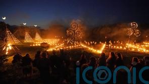 Spectators gather for ancient Celtic fire procession that welcomes summer