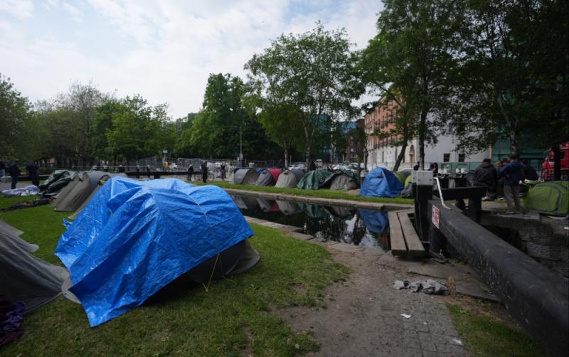 Asylum seeker tents not removed because of Europa League final, says Eamon Ryan