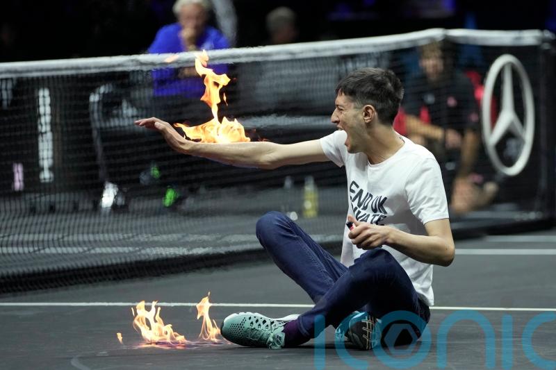 Protester sets his arm on fire during Laver Cup match in London