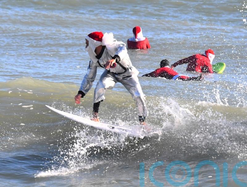Frigid weather fails to stop Florida&rsquo;s surfing Santas