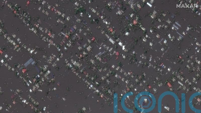 Ukrainian president visits region flooded by breached dam as five confirmed dead