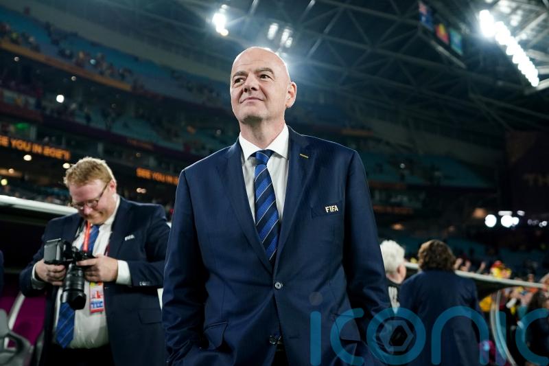 FIFA president Gianni Infantino shows the red card to blue cards