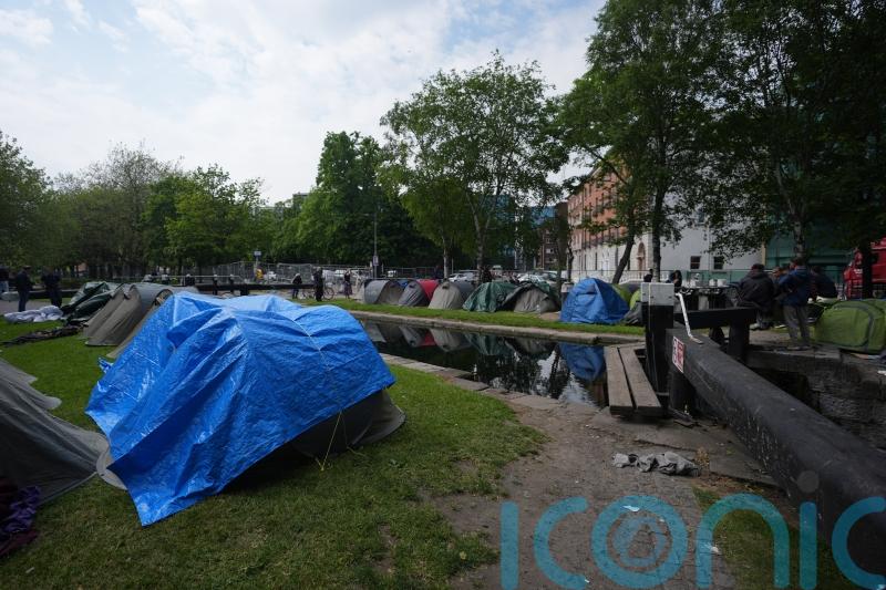 Asylum seeker tents not removed because of Europa League final, insists minister