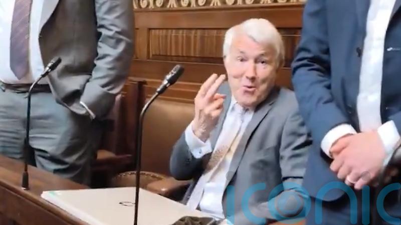 Politician who stuck two fingers up to opposition claims he was provoked