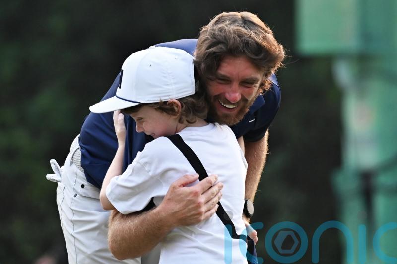 Tommy Fleetwood celebrates with son on 18th green after victory in Delhi