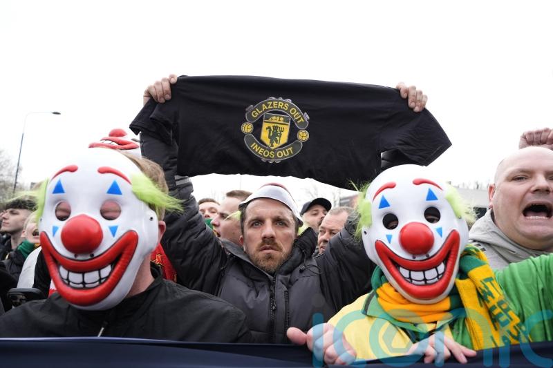 Man Utd supporters wear clown masks in protest ahead of Fulham match